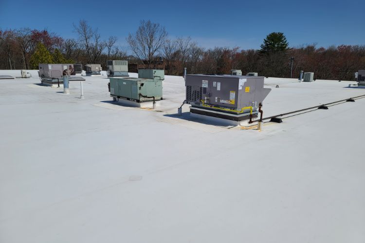contractor installing flat roofing in Rhode Island